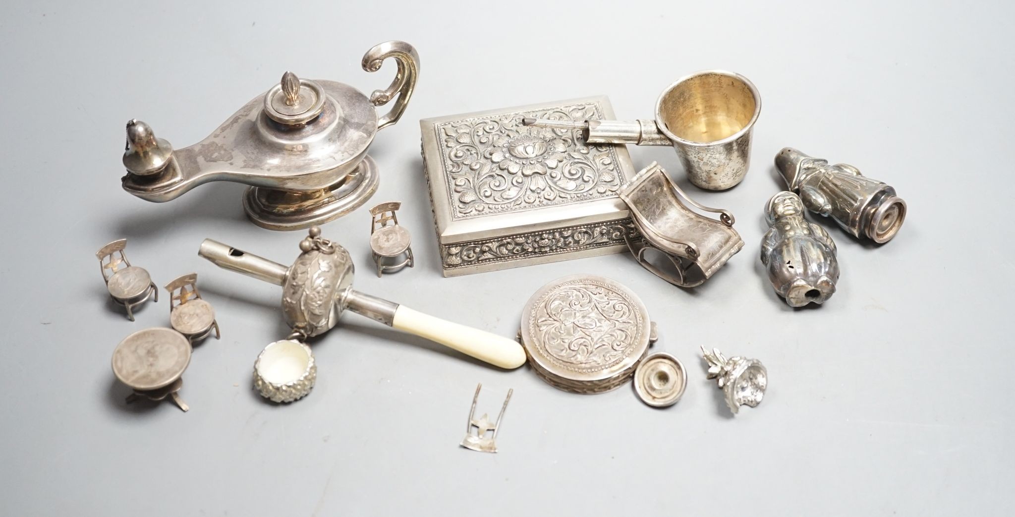 A group of small continental white metal items including a 800 compact, coin mounted miniature furniture, cigarette box, plated lamp lighter, etc.